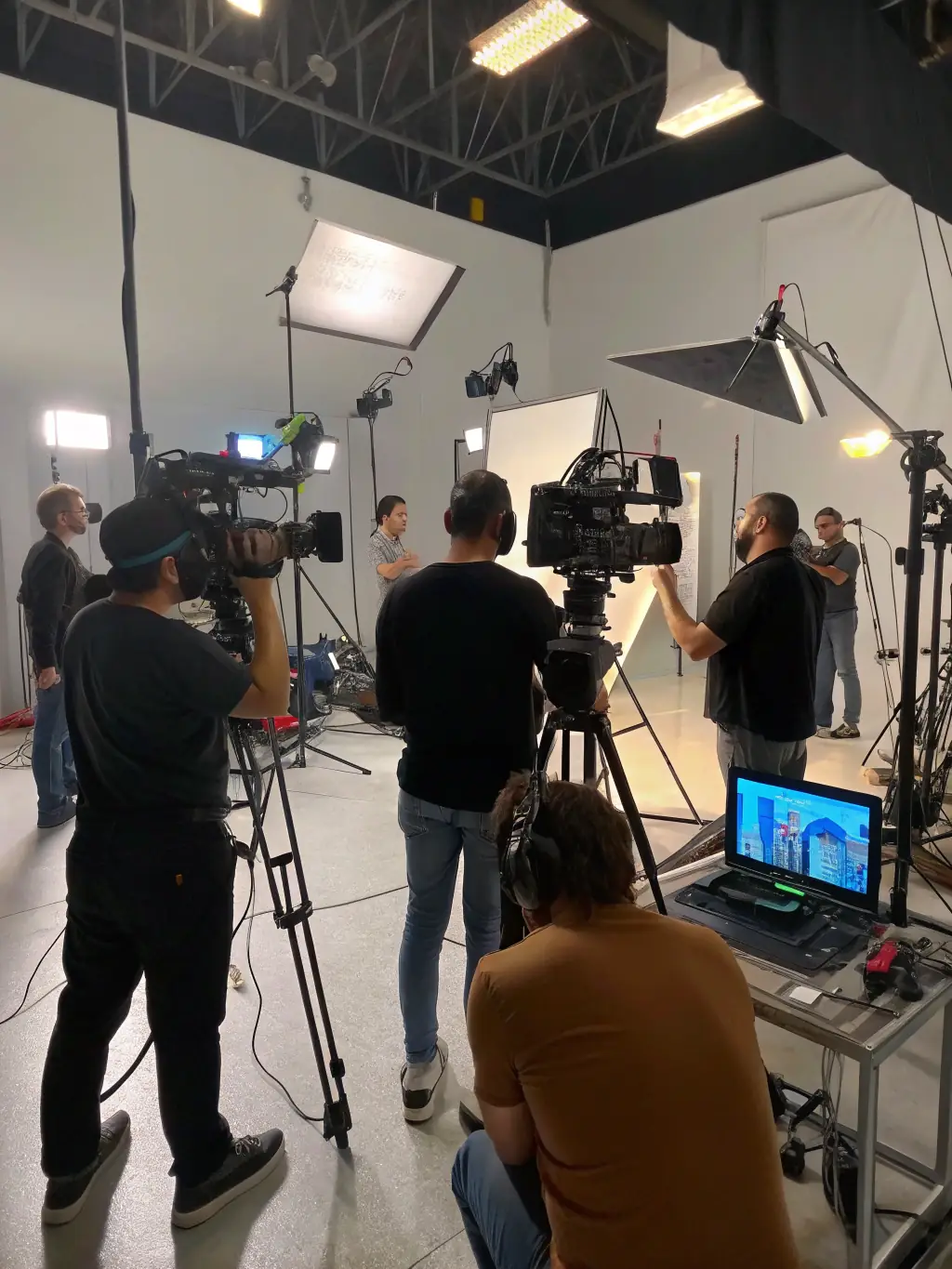 A digital media production team working on a video project, capturing interviews and footage that highlight cultural narratives.